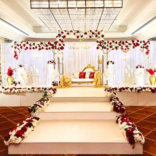 Book a wedding carpet stage Dubai today. Rectangular arches with flowers, wooden stage over carpet and 3 seater sofa included.